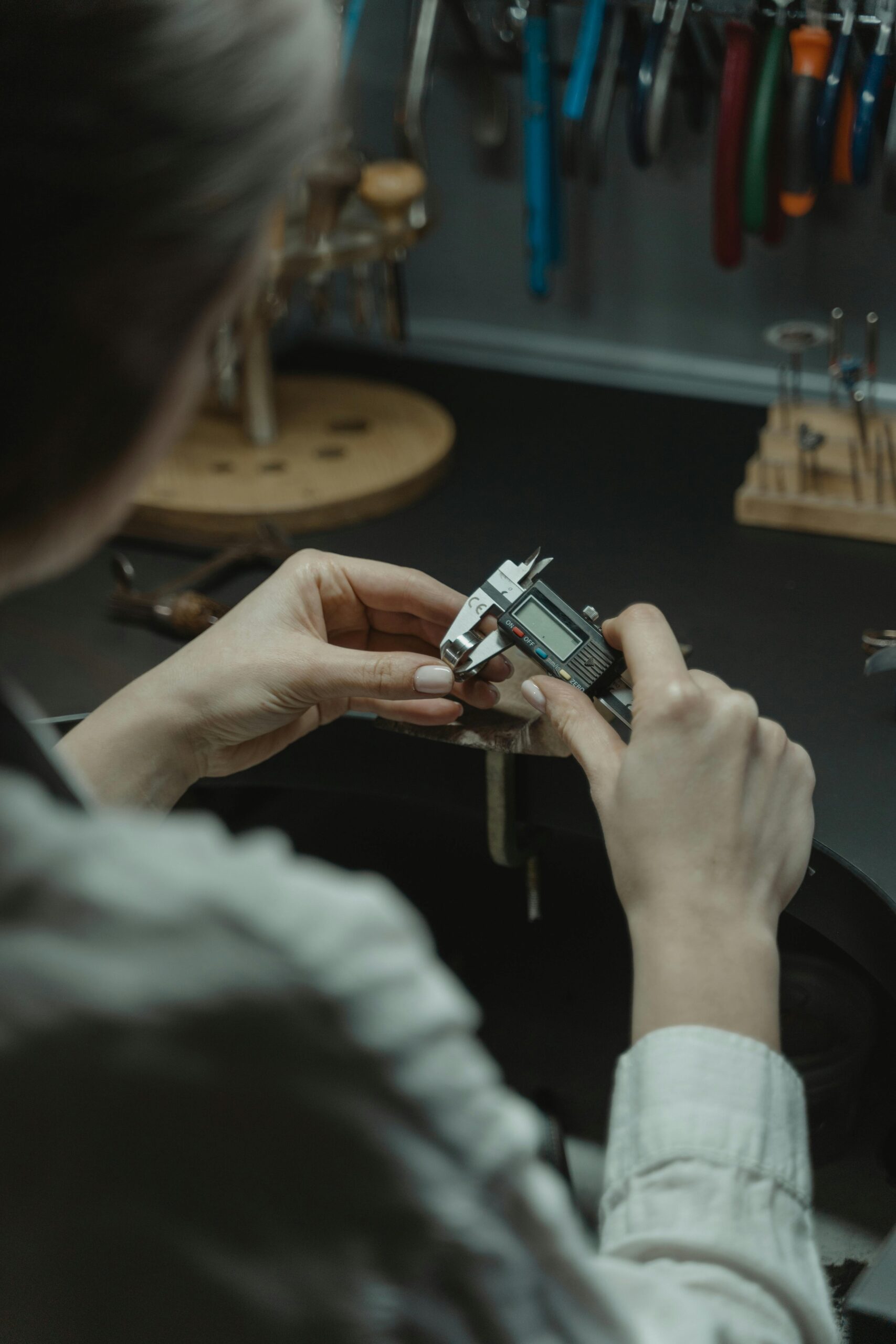 Woman Using a Caliper on Jewelry